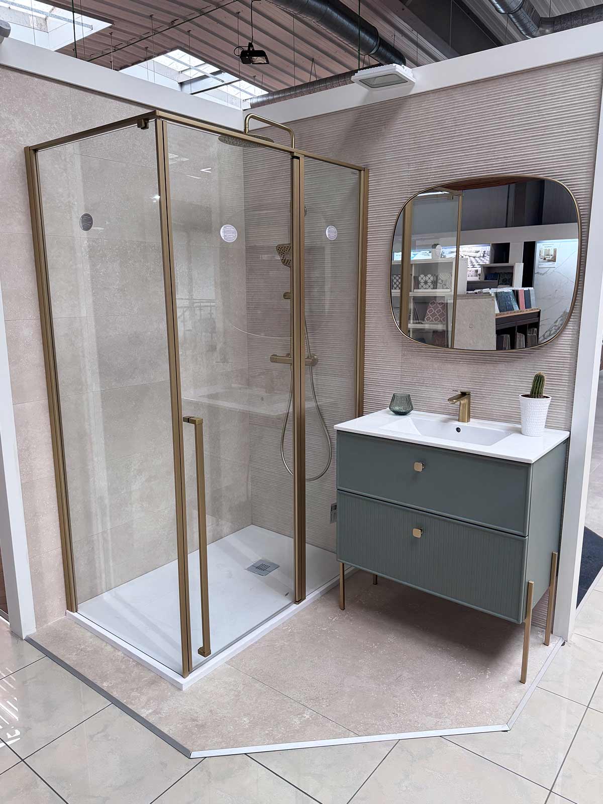 Baño con mampara de ducha y grifería en acabado dorado